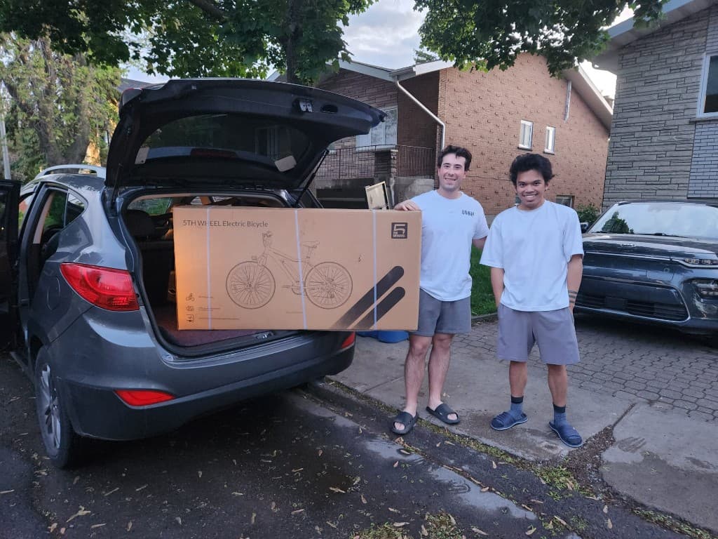 John with his new electric bicycle delivered in the trunk of an SUV